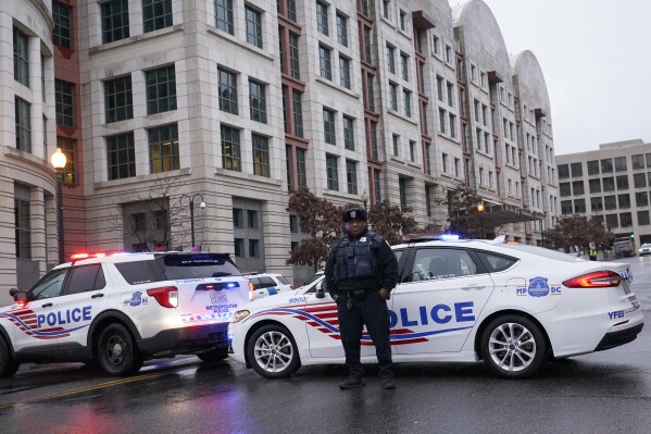 Police stand guard as they wait for former President Donald Trump to arrive at federal court house in Washington, Tuesday, Jan. 9, 2024. (AP Photo/Susan Walsh)